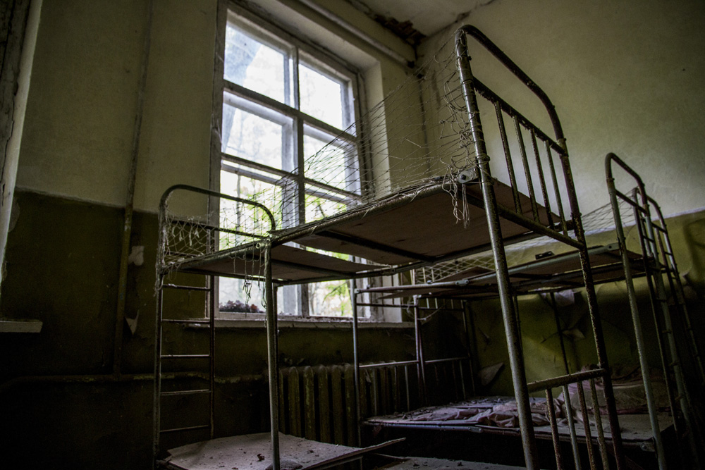 old beds in abandoned nursery in Chernobyl