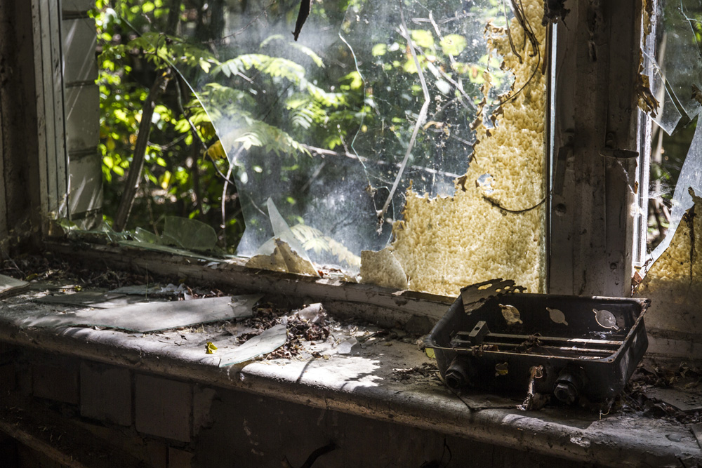 light pours through the windw of an abandoned building in Chernobyl