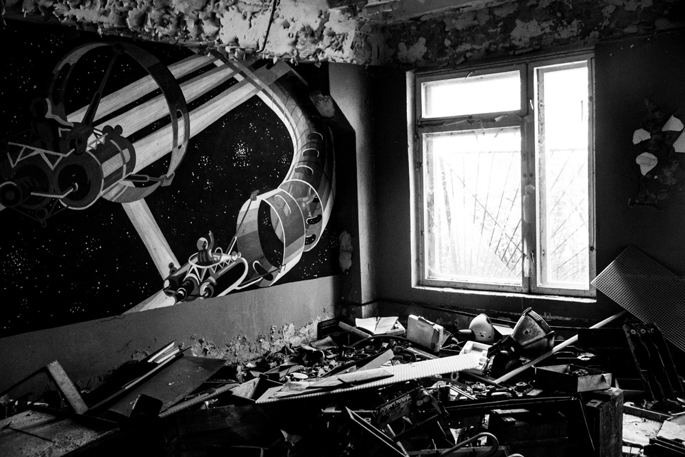 room in the abandoned Chernobyl nuclear exclusion zone with space travel themed mural