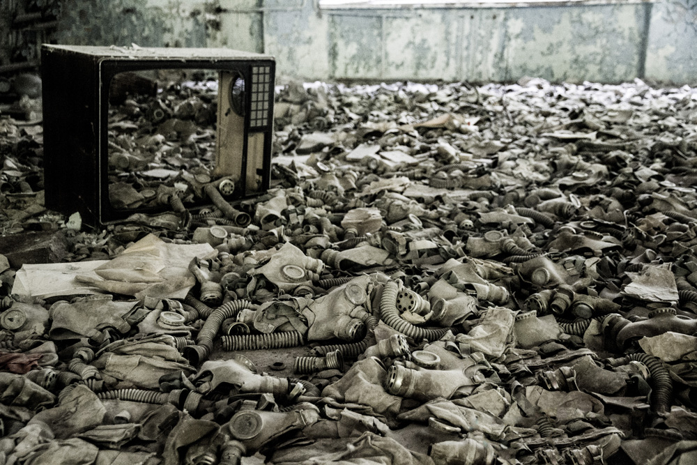 a floor littered with discarded gas masks