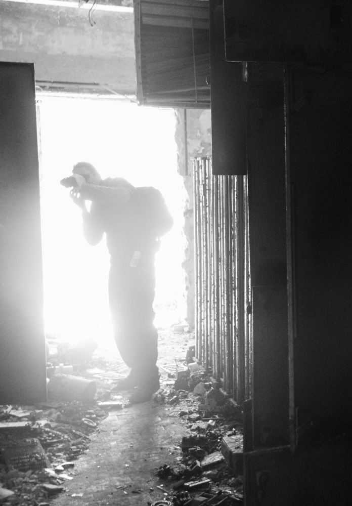 a person explores the ruins of the abandoned city of Pripyat, Chernobyl