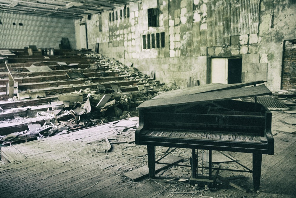 piano in a long abandoned music school in Pripyat, Chernobyl