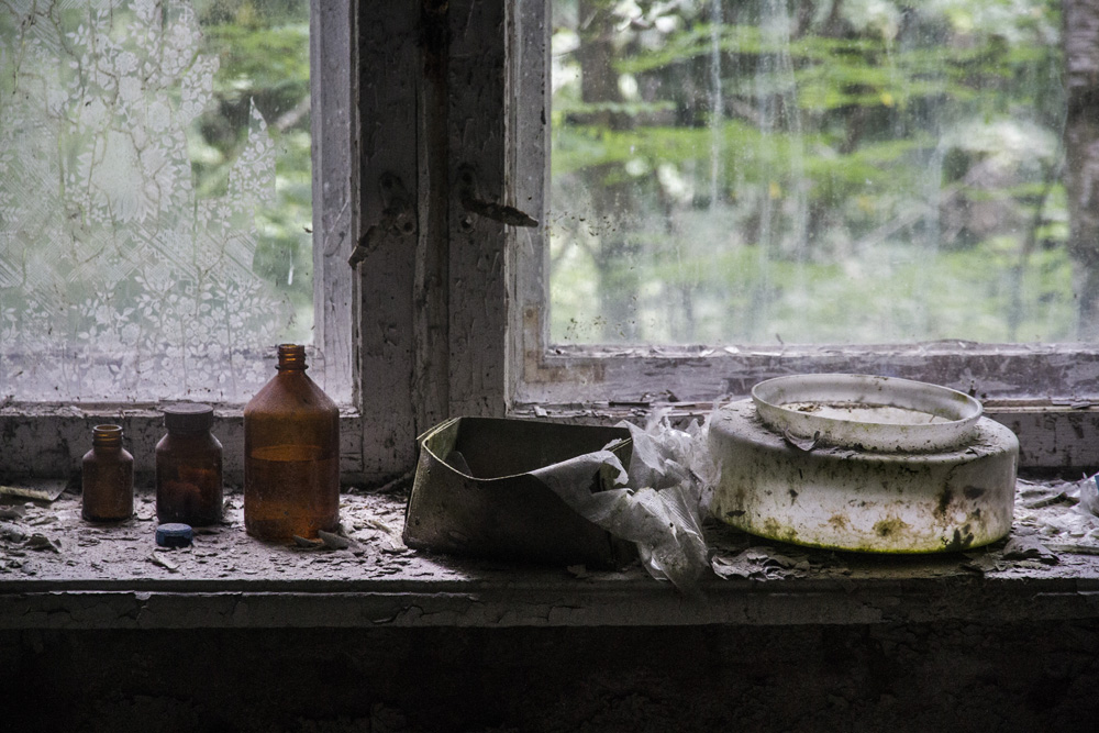 old items by a window in an abandoned building in Chernobyl